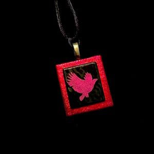 Dichroic glass iridescent red bird in flight pendant with silver bale